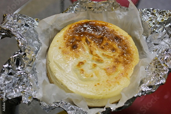 Obraz Basque burnt cheesecake on wooden table in baking room. High quality 4k footage