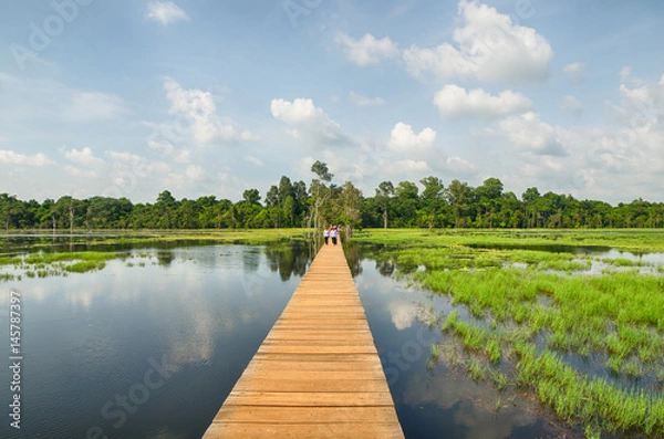 Obraz The wooden path towards to Neak Pean temple on artificial island. Angkor.