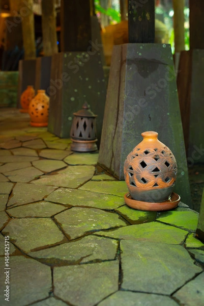 Fototapeta Beautiful oriental decorative terracotta lantern on paved stone floor, with shallow depth of field