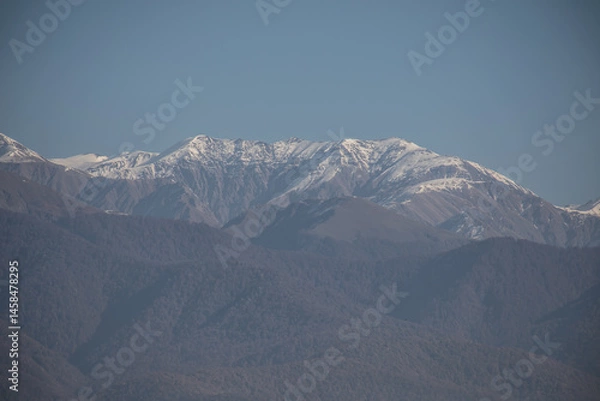 Fototapeta Landscape with beautiful fog in forest on hill or Trail through a mysterious winter forest with autumn leaves on the ground. Road through a winter forest. Magical atmosphere. Azerbaijan nature