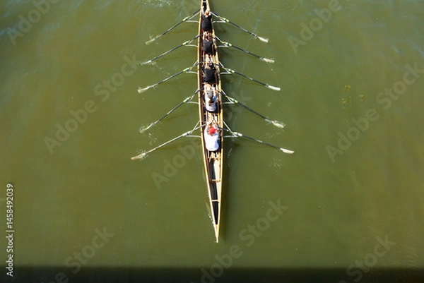 Obraz Academic rowing, four athletes with a coxswain sail in a boat on open water. Academic rowing competition.