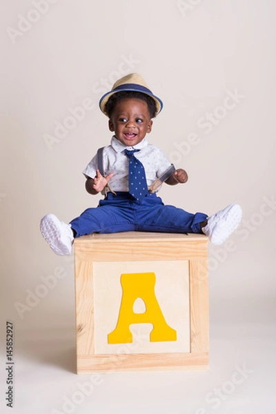 Obraz Happy one year old boy sitting on a box 