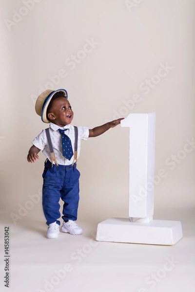 Obraz Adorable one year old boy standing next to the number one 