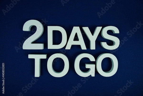 Fototapeta 2 Days to go alphabet letters top view on navy blue background
