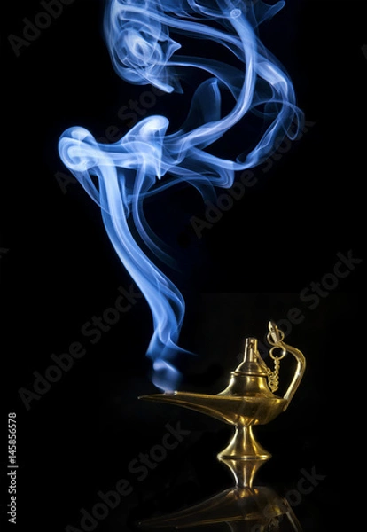 Obraz Magic Aladdin lamp with smoke on a dark background