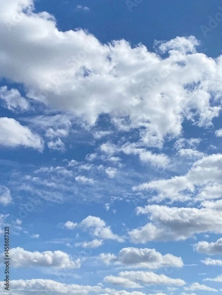 Fototapeta Cumulus clouds in the sky. Vertical image.