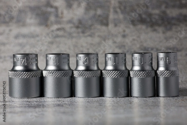 Obraz Replacement heads for ratchet wrench on grey background
