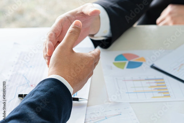 Fototapeta Close up of businessman hands agreeing to cooperate by shaking hands in unity of sustainability green nature business