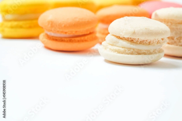 Fototapeta Colorful macaroon on white background, the sweet course eaten at the end of a meal..