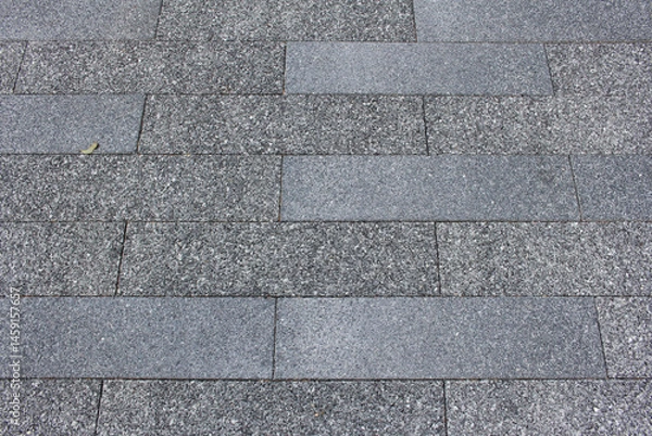Fototapeta Texture of square paving tile. Pattern of gray sidewalk tiles in the street. Concrete pavers close up background.