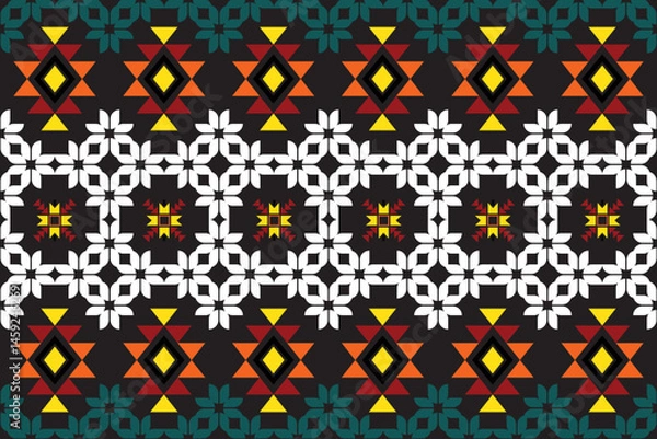 Fototapeta A seamless ethnic geometric pattern with vibrant colors, tribal-inspired motifs and symmetrical elements, ideal for textile prints, boho fashion, or digital backgrounds with a modern folk-art feel.