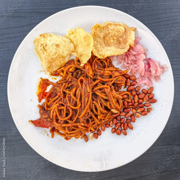 Fototapeta A plate of noodles with assorted toppings.
