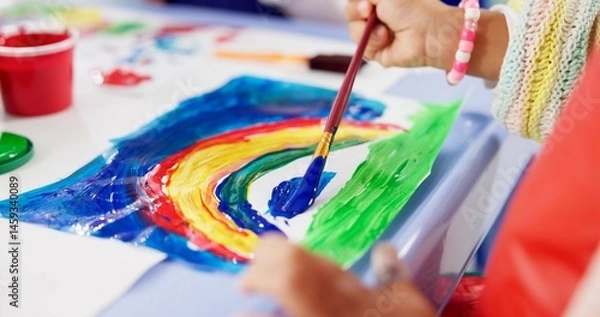 Fototapeta Kindergarten, hands and kid with painting for education, creativity and skills development. Preschool, drawing and child as student for rainbow project, learning or motor growth in closeup with brush