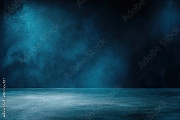 Fototapeta Dark, moody studio background with a cool blue, misty atmosphere.  A smooth, slightly reflective, dark surface floor takes center stage