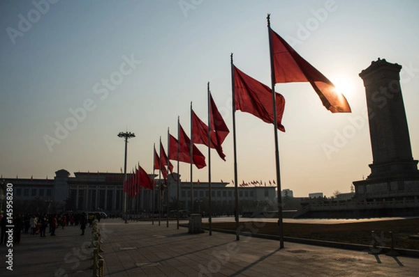 Fototapeta Chinese Flags Swaying in the Morning Breeze with Sunshine at Tiananmen Square, Beijing, China