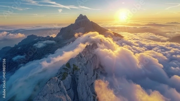 Fototapeta Beautiful landscape of sun in behind a mountain covered in white clouds sky