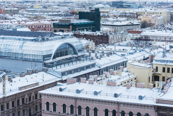 Obraz Old buildings roofs under the snow.