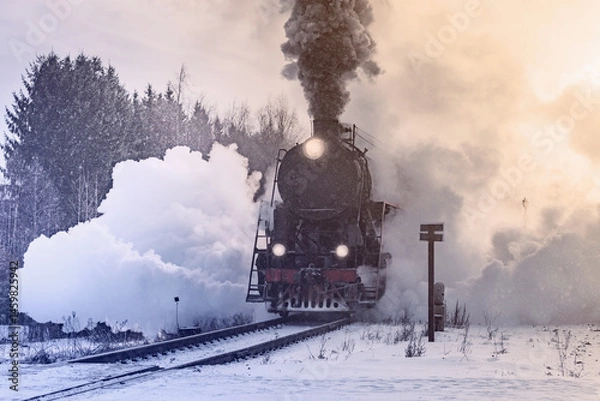 Obraz Retro steam train departs at winter morning.