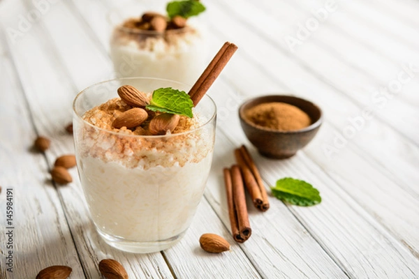 Fototapeta Creamy rice pudding topped with cinnamon and almond