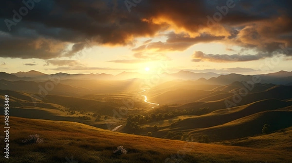 Obraz Golden sunset over rolling hills with a winding river and dramatic clouds in the sky above the horizon