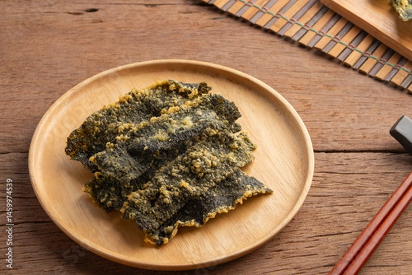 Fototapeta Deep fried Crispy Seaweed with flour and egg.Snack seaweed tempura chips in white plate.