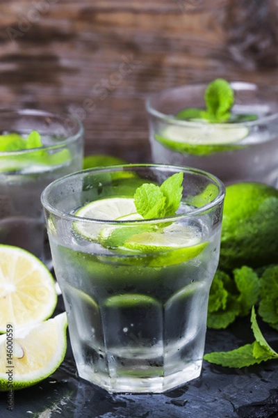 Fototapeta Mojito cocktail in a bur on a rustic table, selective focus