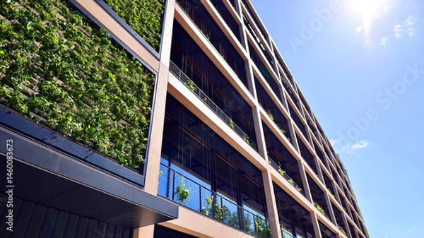Fototapeta Green office building with plants on the facade. Ecology and green living in city, urban environment concept. Eco architecture. 