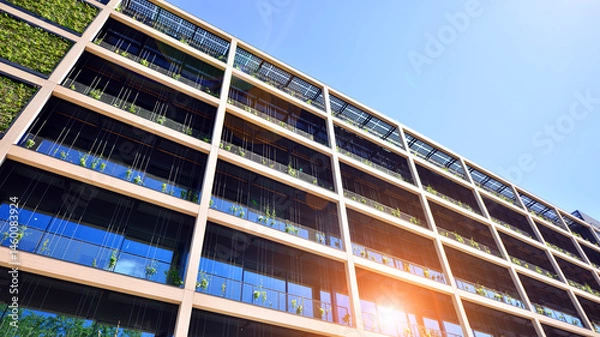 Fototapeta Green office building with plants on the facade. Ecology and green living in city, urban environment concept. Eco architecture. 