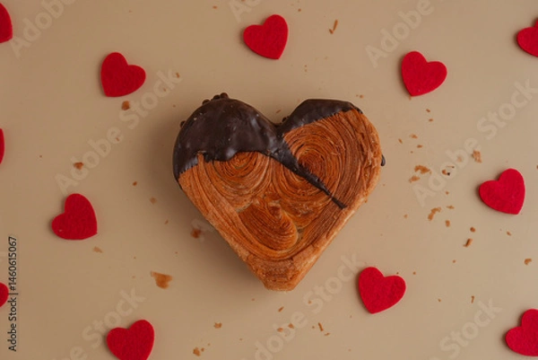 Fototapeta Flat lay top view Delicious fresh croissant topped with Dark chocolate flavor Ganache. Creation unique heart shape bakery. Puff pastry holiday love gift present idea Valentine's day. Copy space 