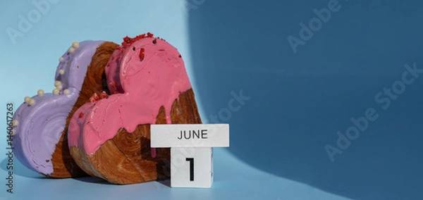 Fototapeta Calendar date 1 June International children's day greeting card Delicious fresh croissant topped with colorful flavor Ganache. Creation unique heart shape bakery. Puff pastry holiday love gift present