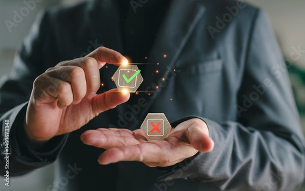 Fototapeta Businessman holding check mark and cross symbols representing decision making, risk assessment, correct vs incorrect choices, evaluation process, and business strategy concept.