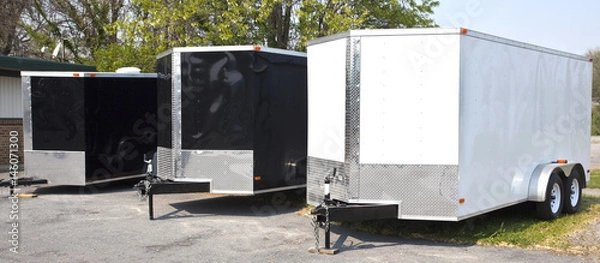 Fototapeta Three black and white transport trailers in a row.