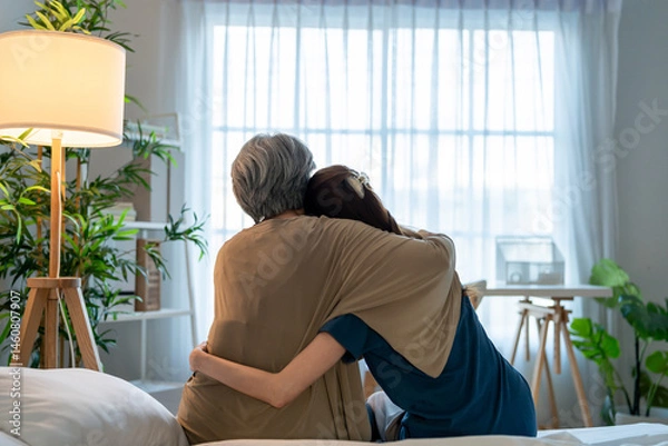 Obraz Rear view of elderly mother comfort upset daughter crying for problem. 