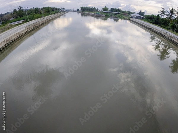 Fototapeta Calm River Canal Reflecting Cloudy Sky