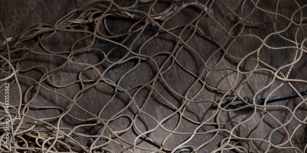 Fototapeta Fishing net on rustic old wood, fishing concept, art craft themes
