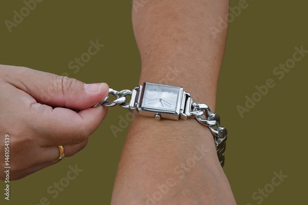 Fototapeta Isolated hand wearing watch of woman with clipping paths.