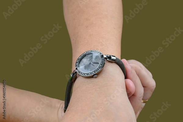 Fototapeta Isolated hand wearing watch of woman with clipping paths.