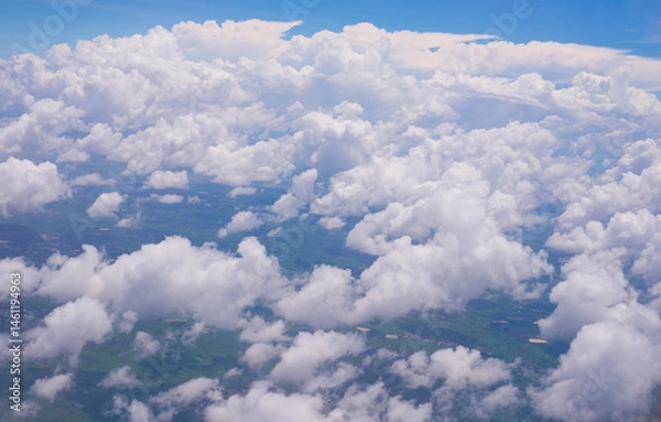 Fototapeta clouds in the blue sky, view from the airplane window.