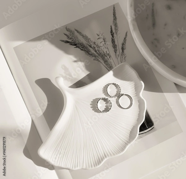 Fototapeta White podium leaf for jewerly and rings on white soft shadow background monochrome black and white. Copy space. Abstract minimal showcase, display. Top view, Flat lay.