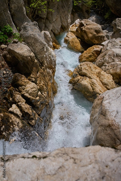 Fototapeta Mountain stream rushing through rocks