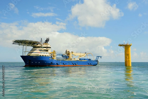 Fototapeta DP3 Cable Laying Vessel Positioned Next to Offshore Wind Turbine Foundation With ROV Deployed