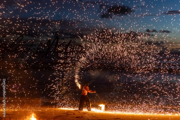 Fototapeta Fire performer lights up the beach, creating beautiful patterns against a sunset backdrop. 