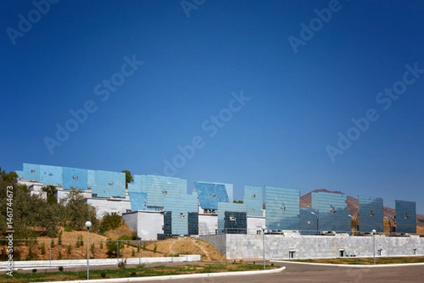 Fototapeta Solar furnace ( Sun Institute), second largest in world. View of giant sun concentrator on mountain and heliostats