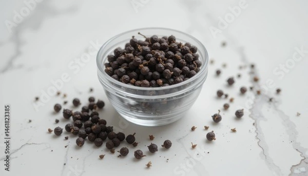 Fototapeta A clear glass jar filled with black peppercorns on a white background, highlighting fresh spices, cooking ingredients, or culinary essentials for food prep and seasoning.