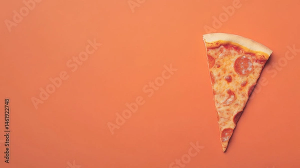 Fototapeta A single slice of pepperoni pizza on a vibrant orange background, showcasing its cheesy goodness.