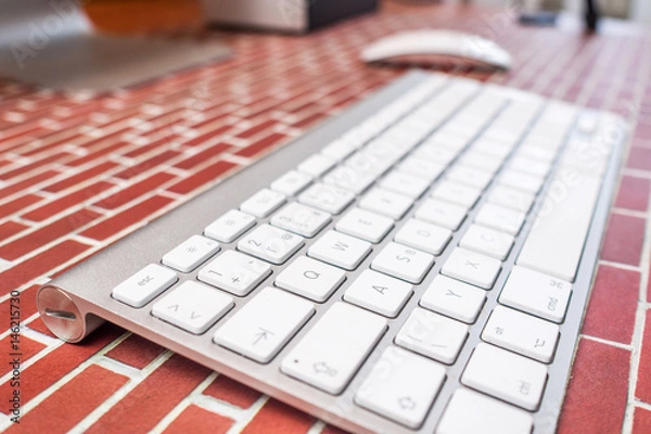 Fototapeta working in office / top view of an office place with modern technology on red brick background