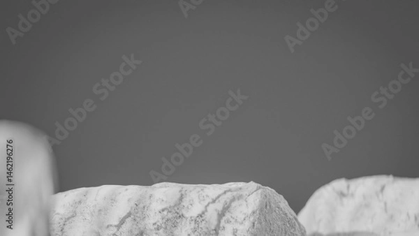 Fototapeta Bottle of perfume is shown on a rocky surface. The bottle is black and has a black cap. The bottle is placed on a rock, and the rock is surrounded by other mossy rocks. Premium photo 3d render.