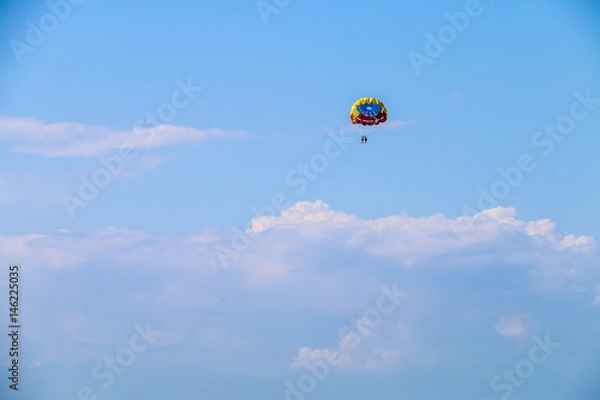 Fototapeta Parachute flight in the clouds