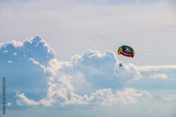 Fototapeta Parachute flight in the clouds
