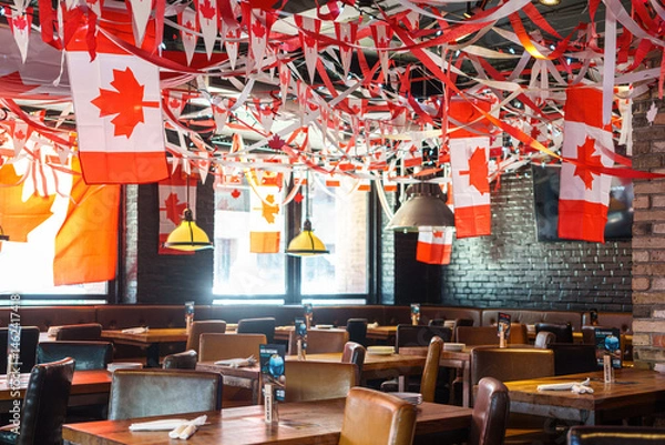 Obraz Indoors of a restaurant decorated with Canadian flags and symbols, Toronto, Canada